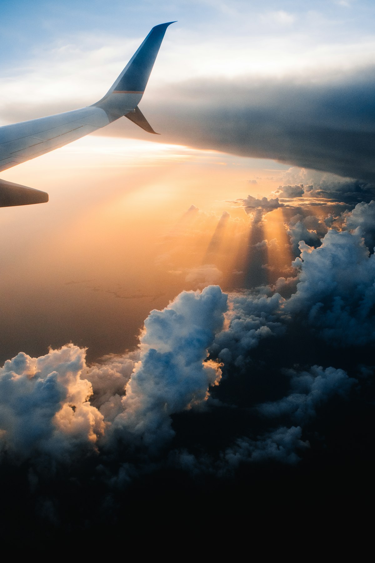 Airplane wing view during a flight over clouds